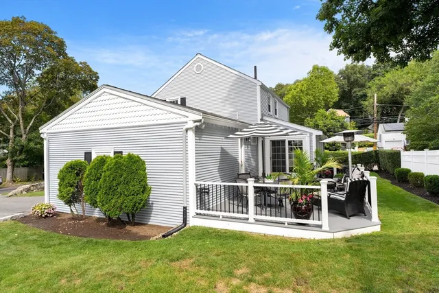 a front view of a house with a yard table and chairs