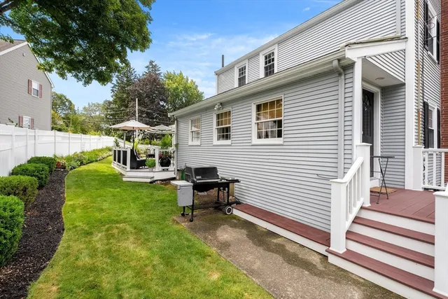 a view of a house with backyard and sitting area