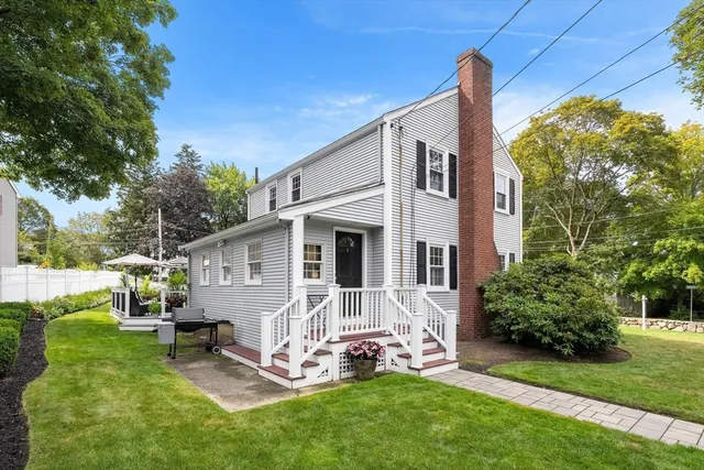 a front view of house with a garden and patio