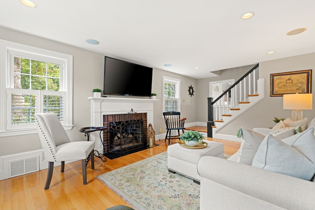 4 Joyce Road Arlington, MA 02474 - Photo 4 of 42 a living room with furniture a fireplace and a flat screen tv