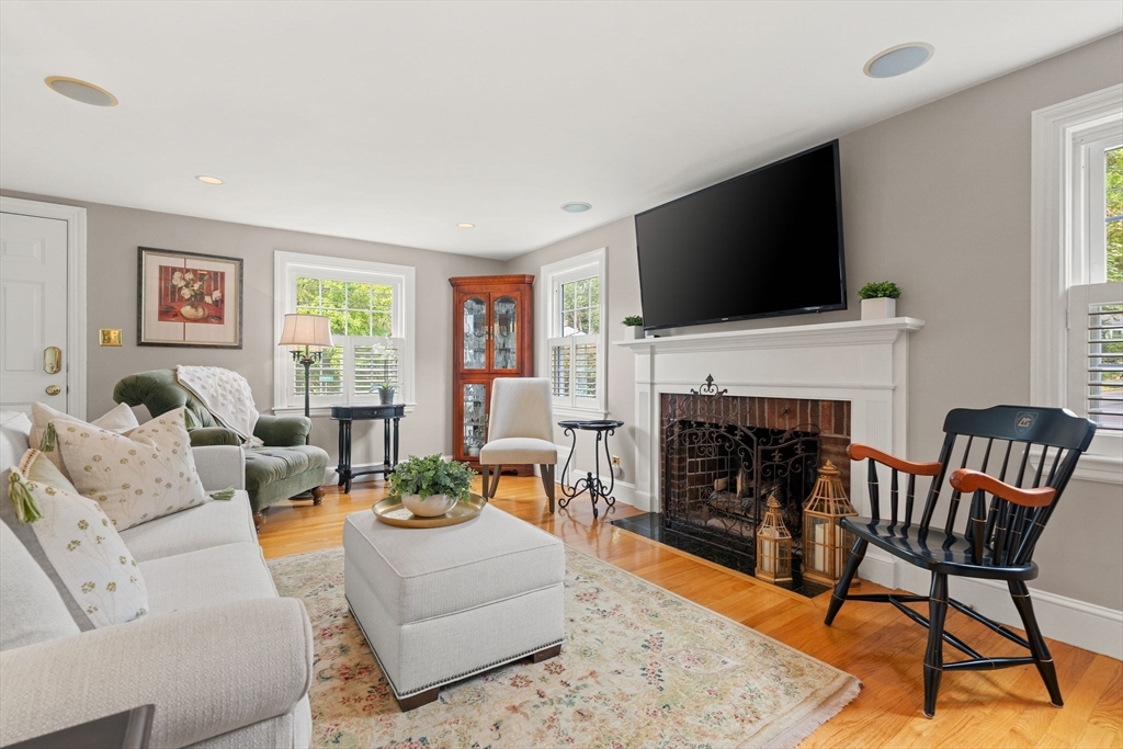 4 Joyce Road Arlington, MA 02474 - Photo 7 of 42 a living room with furniture a fireplace and a flat screen tv