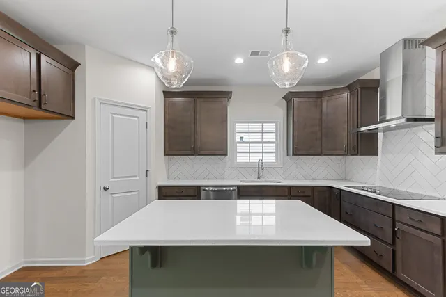 an empty room with windows and fan chandelier fan