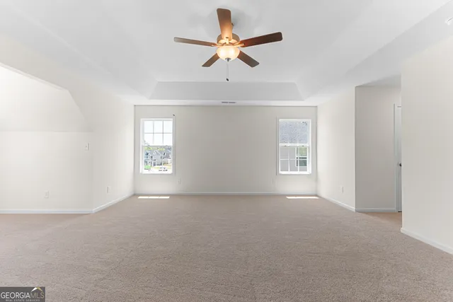 a white bath tub sitting in a bathroom next to a window