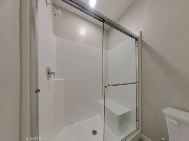 a bathroom with a shower and a toilet