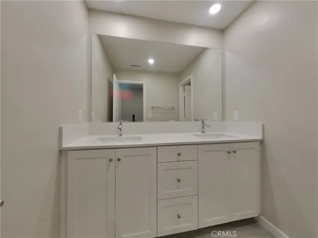 a bathroom with 2 sink and a mirror