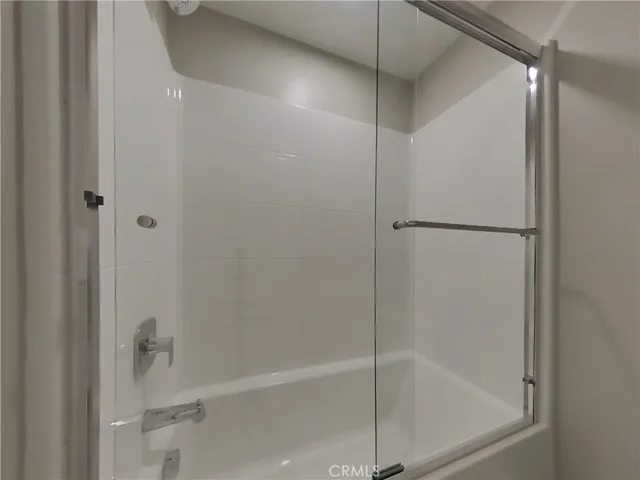 a bathroom with a glass shower door