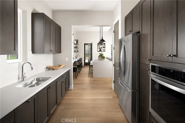 a kitchen with stainless steel appliances a refrigerator and a sink