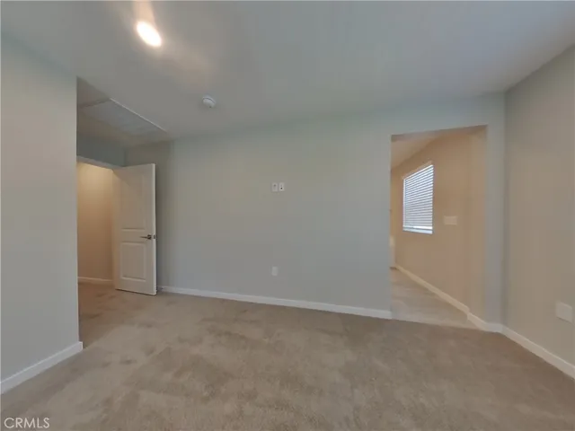 an empty room with window in closet and mirror