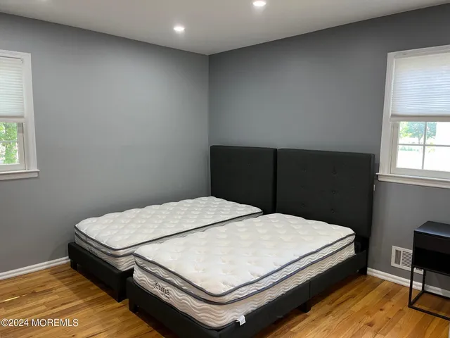 a bedroom with a bed table and window