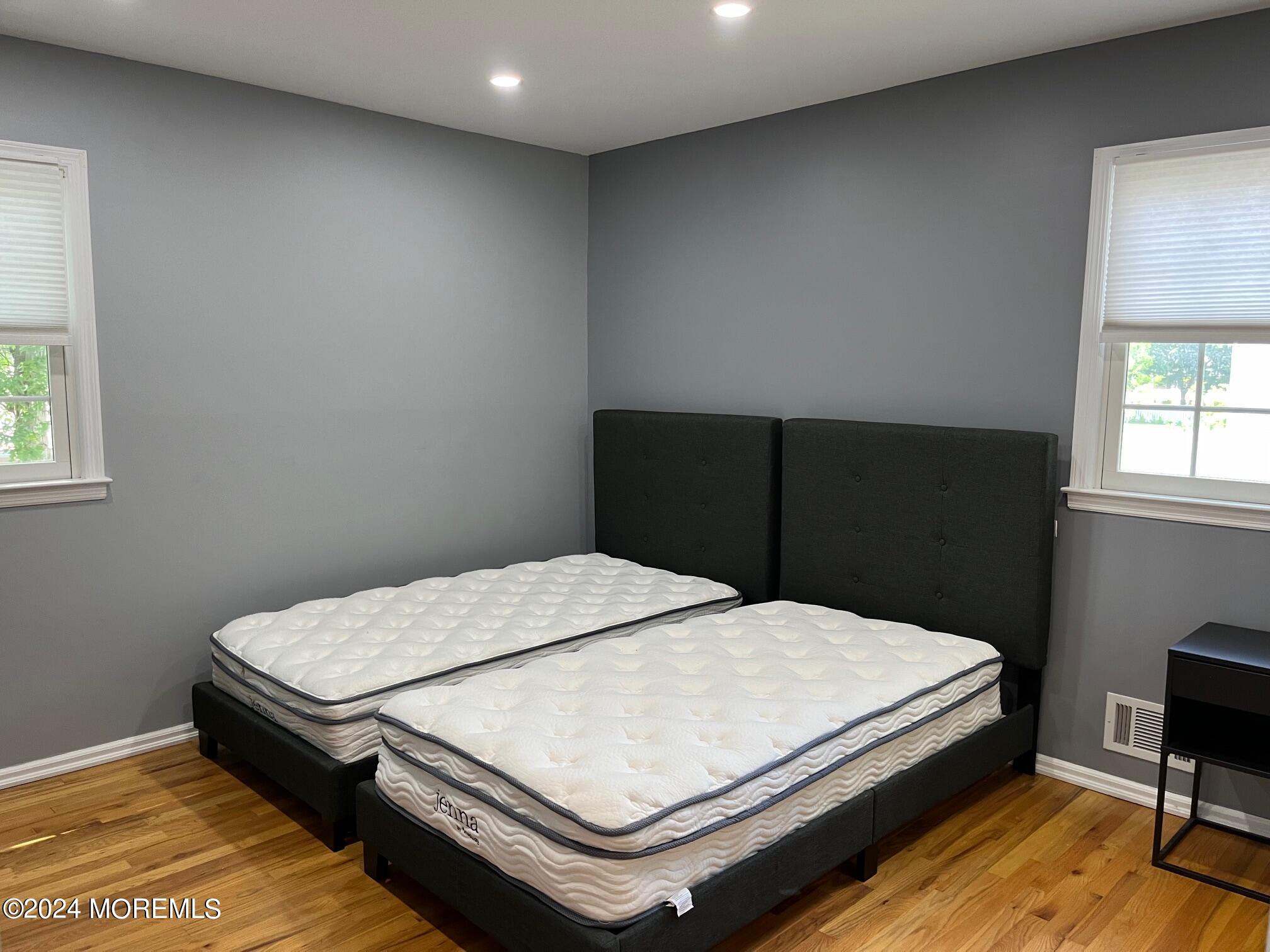 106 Pear Street Oakhurst, NJ 07755 - Photo 11 of 21 a bedroom with a bed table and window