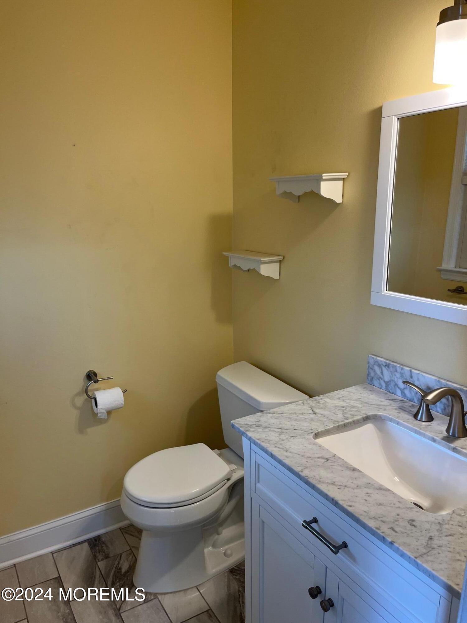 106 Pear Street Oakhurst, NJ 07755 - Photo 12 of 21 a bathroom with a granite countertop toilet and a sink