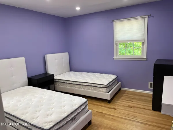 a bedroom with a bed and a potted plant