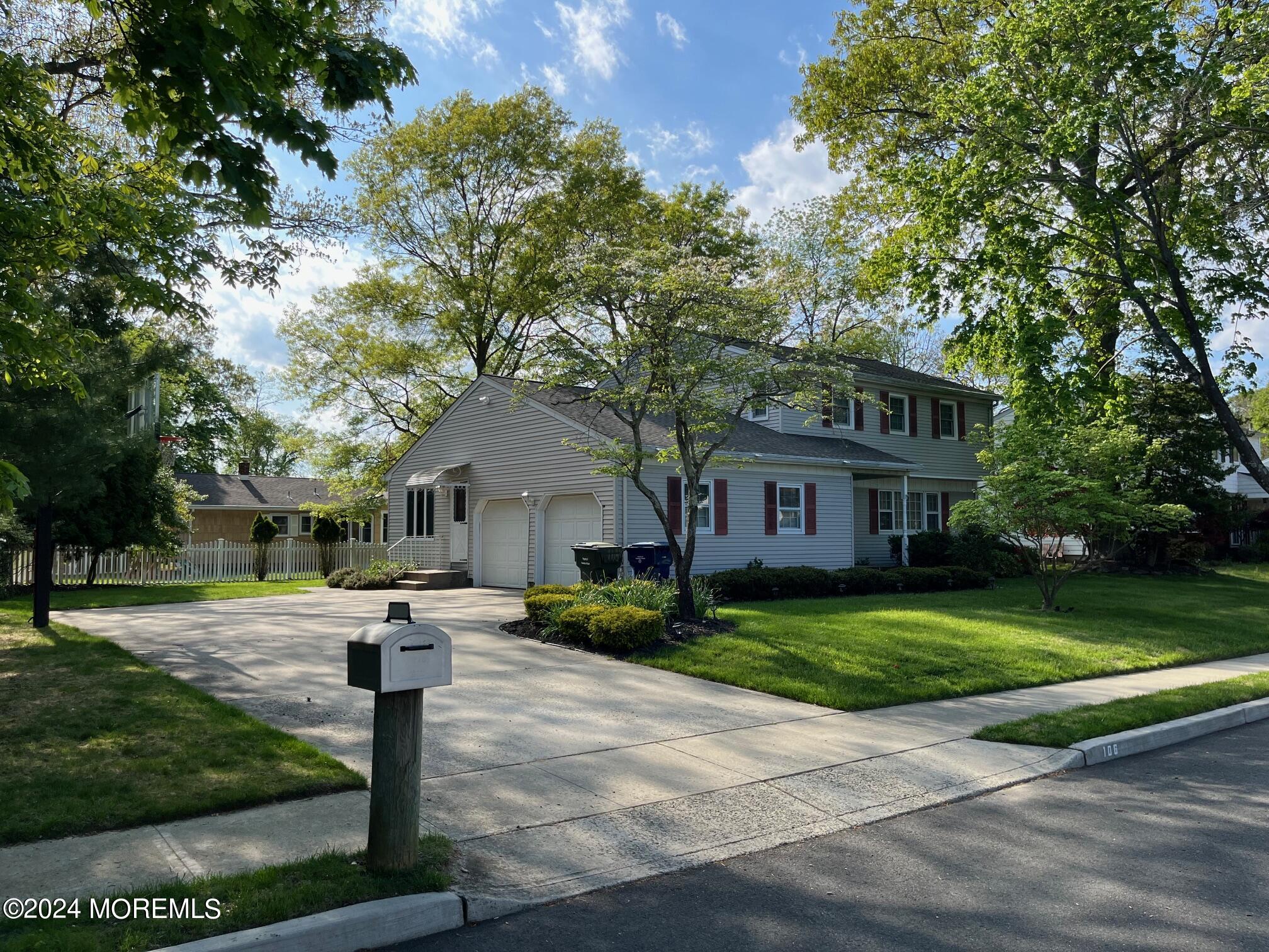 106 Pear Street Oakhurst, NJ 07755 - Photo 2 of 21 a front view of a house with a yard and trees