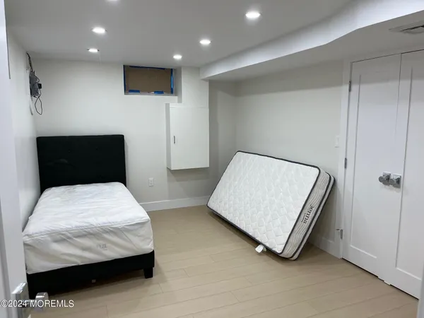 a room with a bed and a night stand