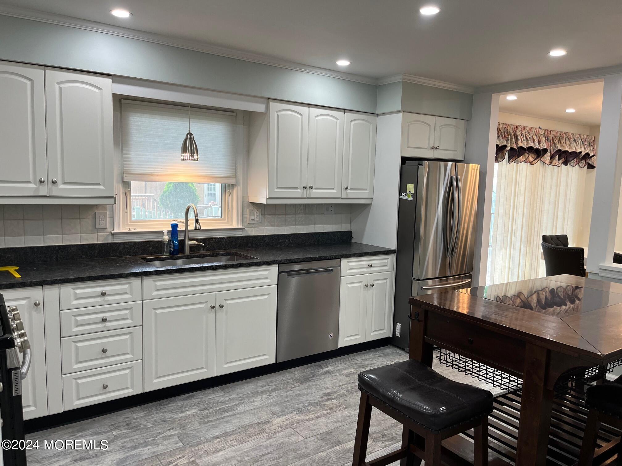 106 Pear Street Oakhurst, NJ 07755 - Photo 4 of 21 a kitchen with stainless steel appliances a refrigerator sink and cabinets