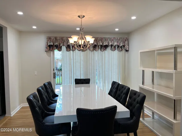 a view of a dining room with furniture and chandelier