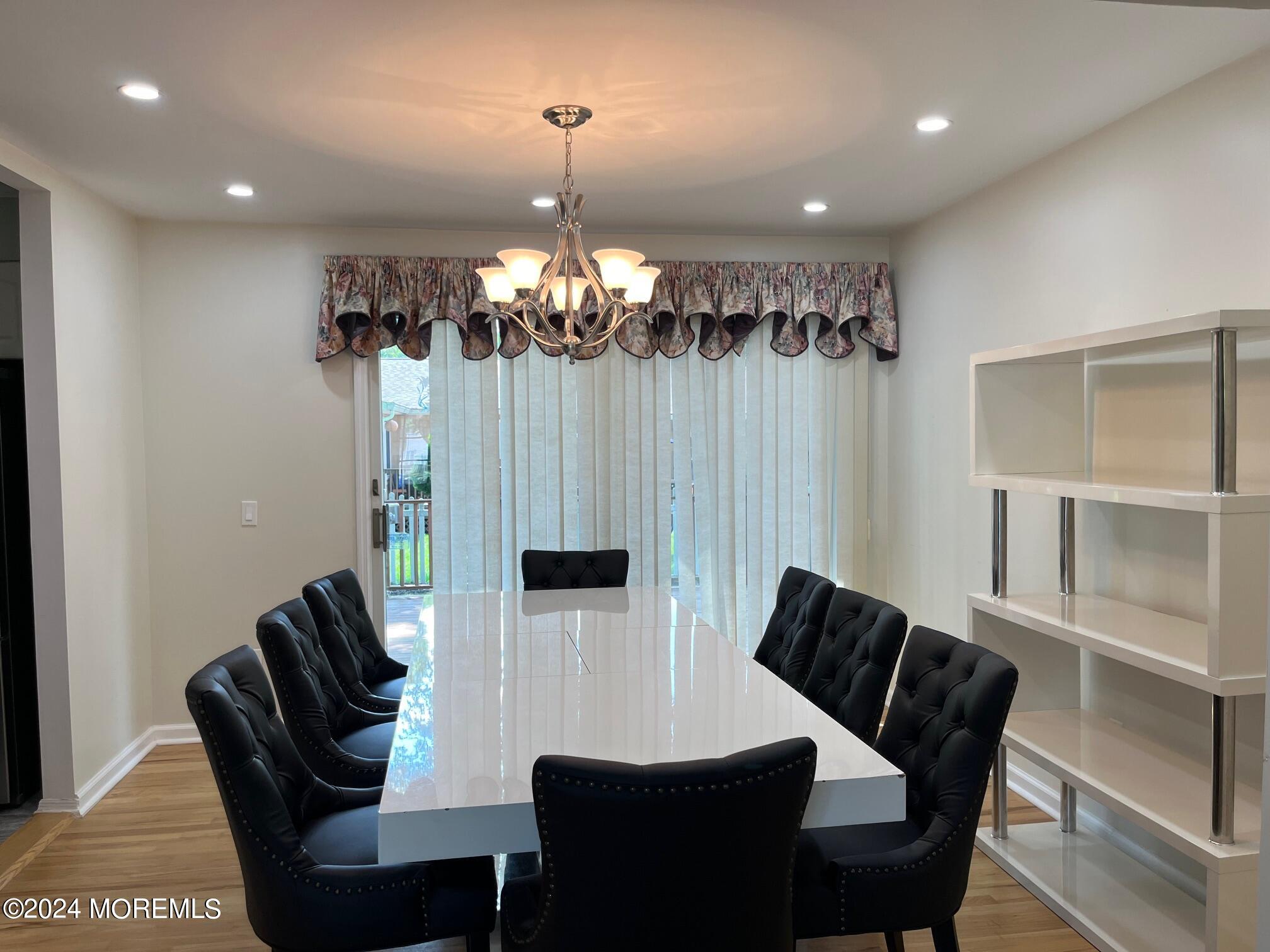 106 Pear Street Oakhurst, NJ 07755 - Photo 6 of 21 a view of a dining room with furniture and chandelier