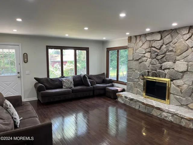 a living room with furniture window and a fireplace