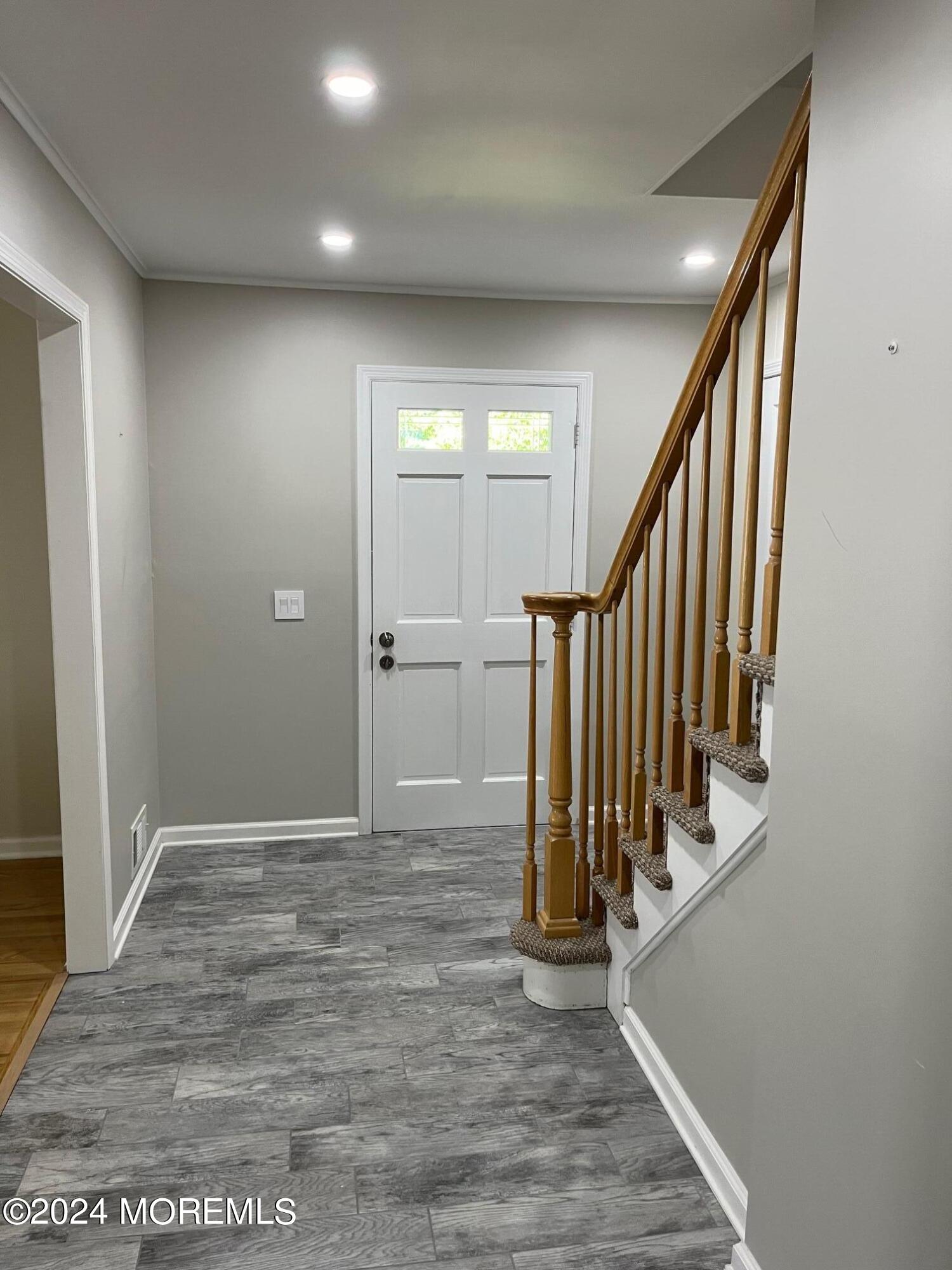 106 Pear Street Oakhurst, NJ 07755 - Photo 10 of 21 a view of a hallway with wooden floor and staircase