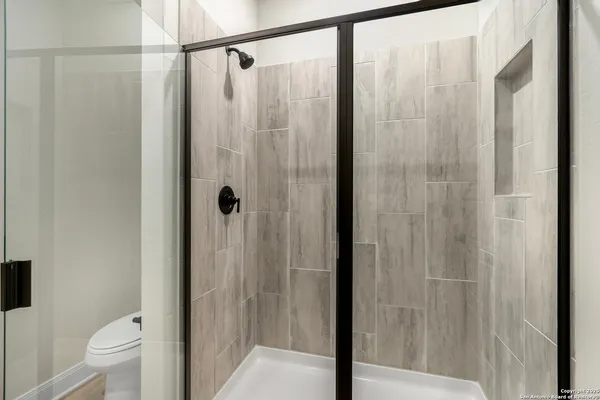 a bathroom with a shower and a toilet