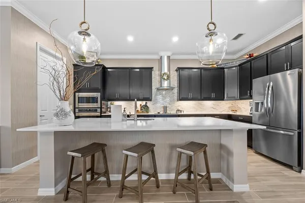 a kitchen with cabinets and stainless steel appliances