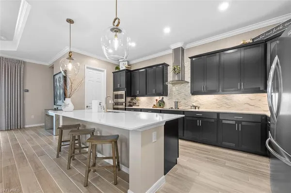 a kitchen with stainless steel appliances a sink stove and refrigerator
