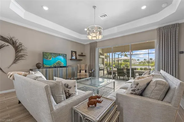 a living room with furniture and a chandelier