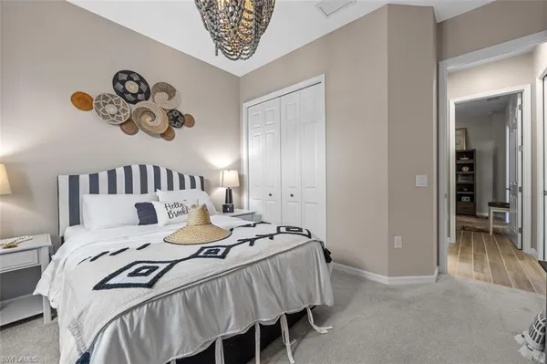 a bedroom with a bed and a chandelier