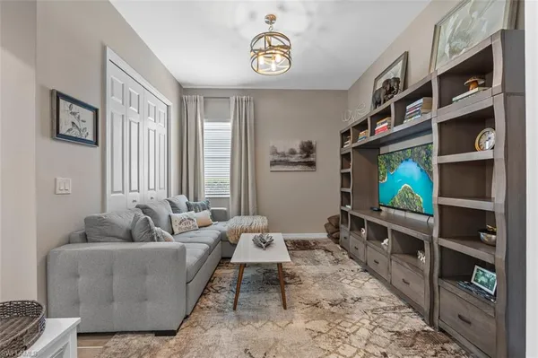 a living room with furniture and a flat screen tv