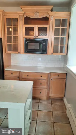 a view of kitchen with wooden cabinets and oven