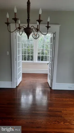 a view of front door and porch with wooden floor