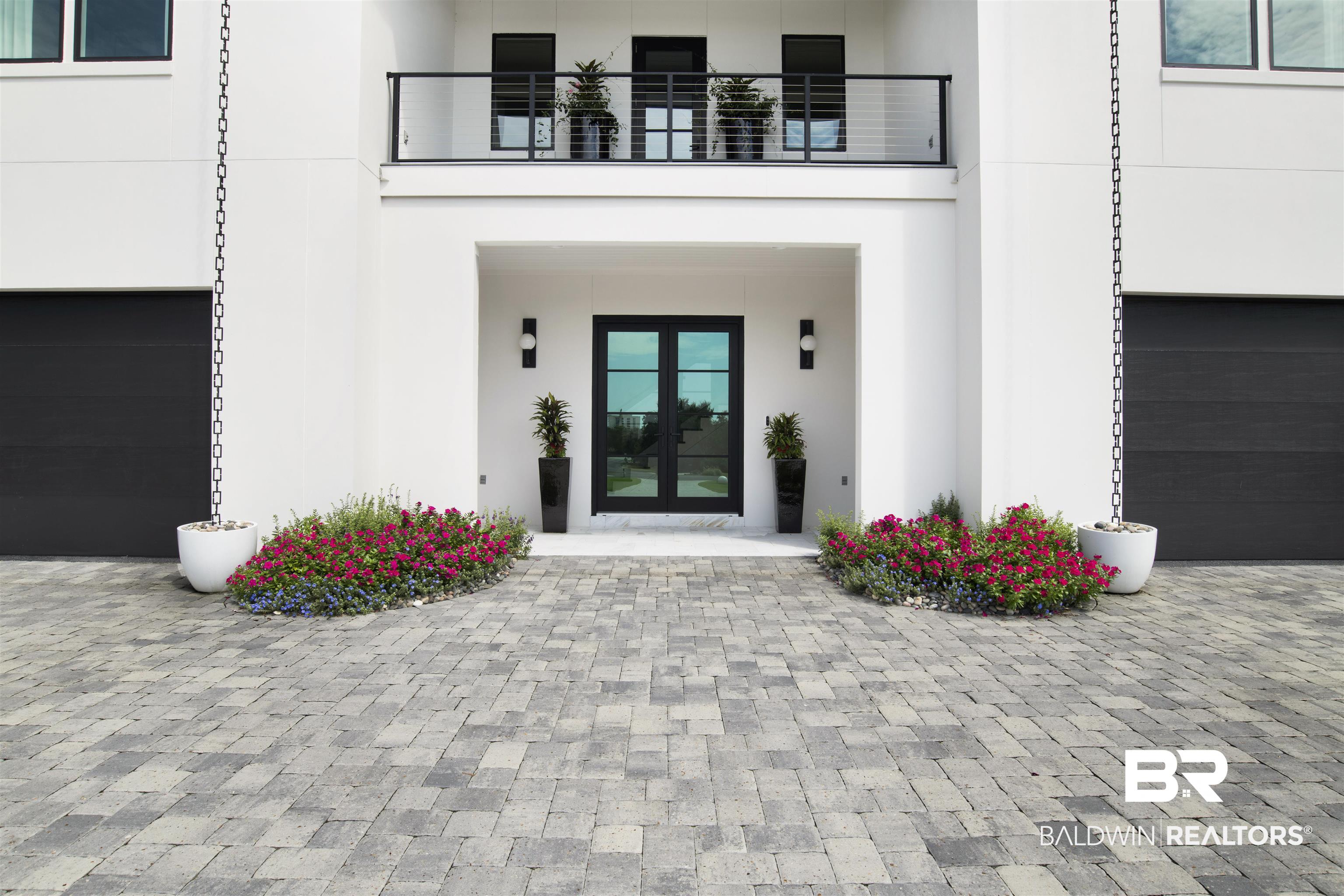 30239 Canal Court Orange Beach, AL 36561 - Photo 8 of 70 Entrance to property with stucco siding, a garage, and decorative driveway
