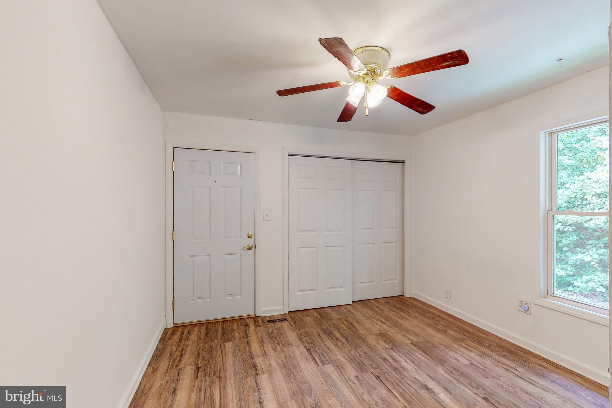 2460 Johnson Road Huntingtown, MD 20639 - Photo 21 of 69 wooden floor in an empty room with a window
