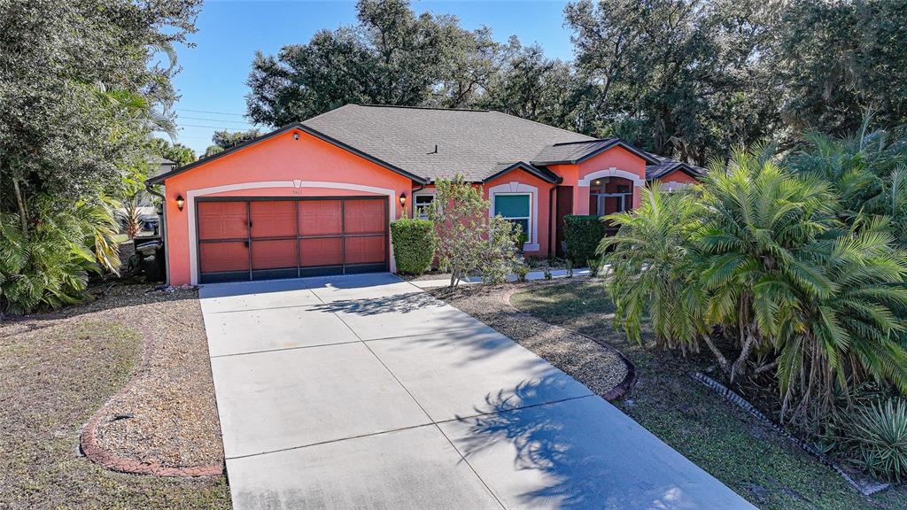 3811 Marshall Road North Port, FL 34288 - Photo 1 of 1 a front view of a house with a yard and garage
