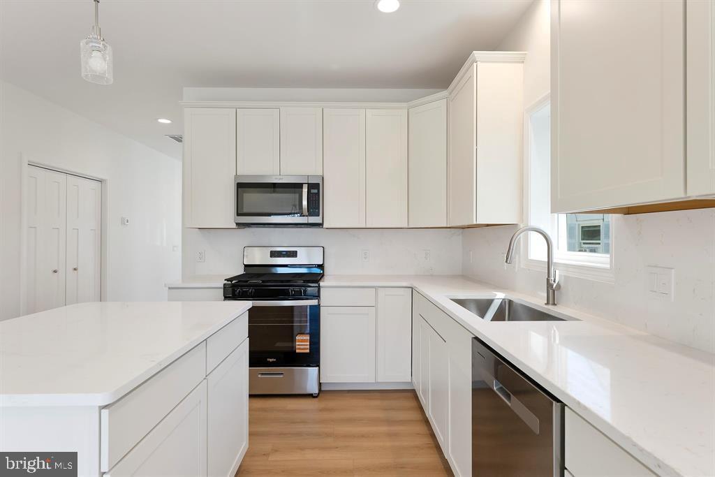 206 Frances Avenue, Unit A Villas, NJ 08251 - Photo 11 of 48 a kitchen with stainless steel appliances granite countertop a sink and a stove