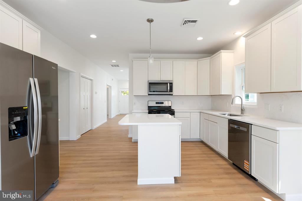 206 Frances Avenue, Unit A Villas, NJ 08251 - Photo 13 of 48 a kitchen with kitchen island white cabinets and stainless steel appliances