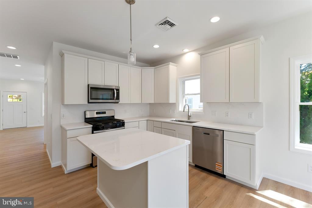 206 Frances Avenue, Unit A Villas, NJ 08251 - Photo 14 of 48 a kitchen with a sink a stove a microwave and cabinets
