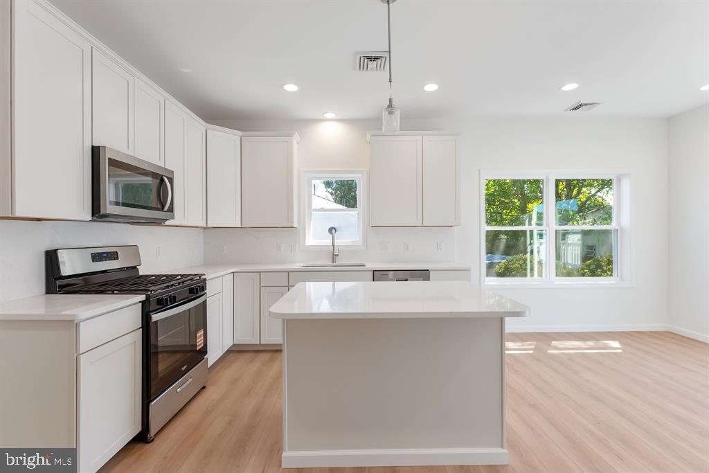 206 Frances Avenue, Unit A Villas, NJ 08251 - Photo 16 of 48 a kitchen with stainless steel appliances granite countertop a sink a stove top oven a counter space and cabinets
