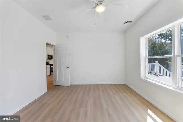a view of a room with wooden floor and windows
