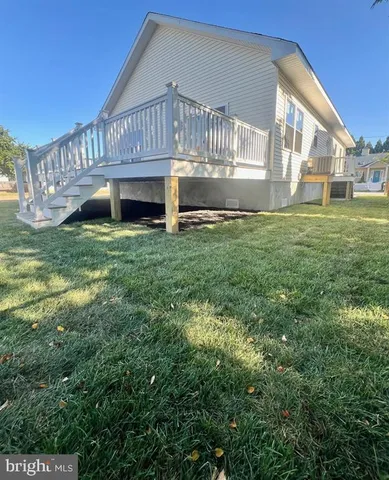 a view of house with backyard and garden