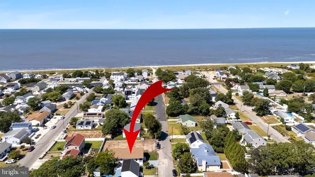 an aerial view of residential houses with outdoor space and swimming pool