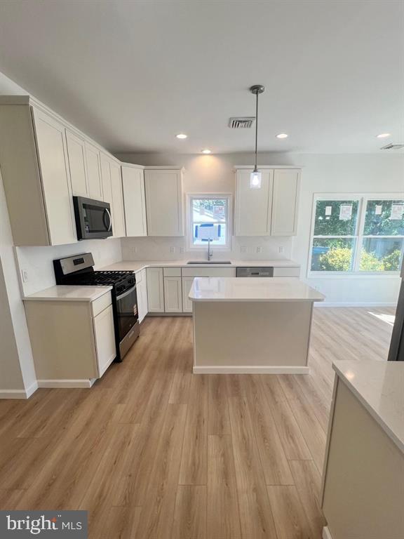 206 Frances Avenue, Unit A Villas, NJ 08251 - Photo 8 of 48 a large kitchen with kitchen island a sink a stove a microwave a center island and cabinets