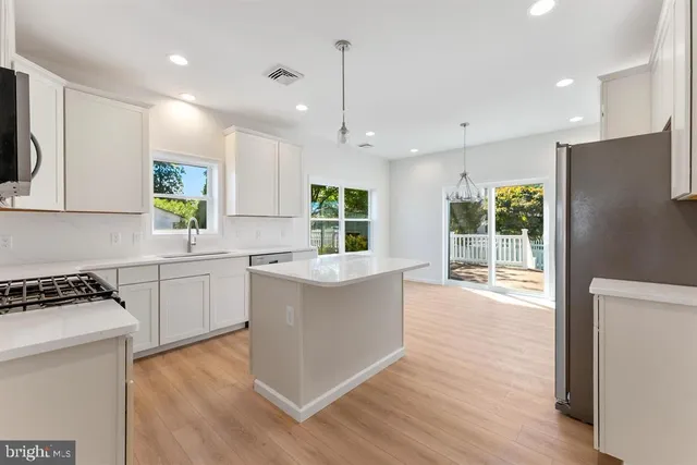 a kitchen with counter top space and wooden floor
