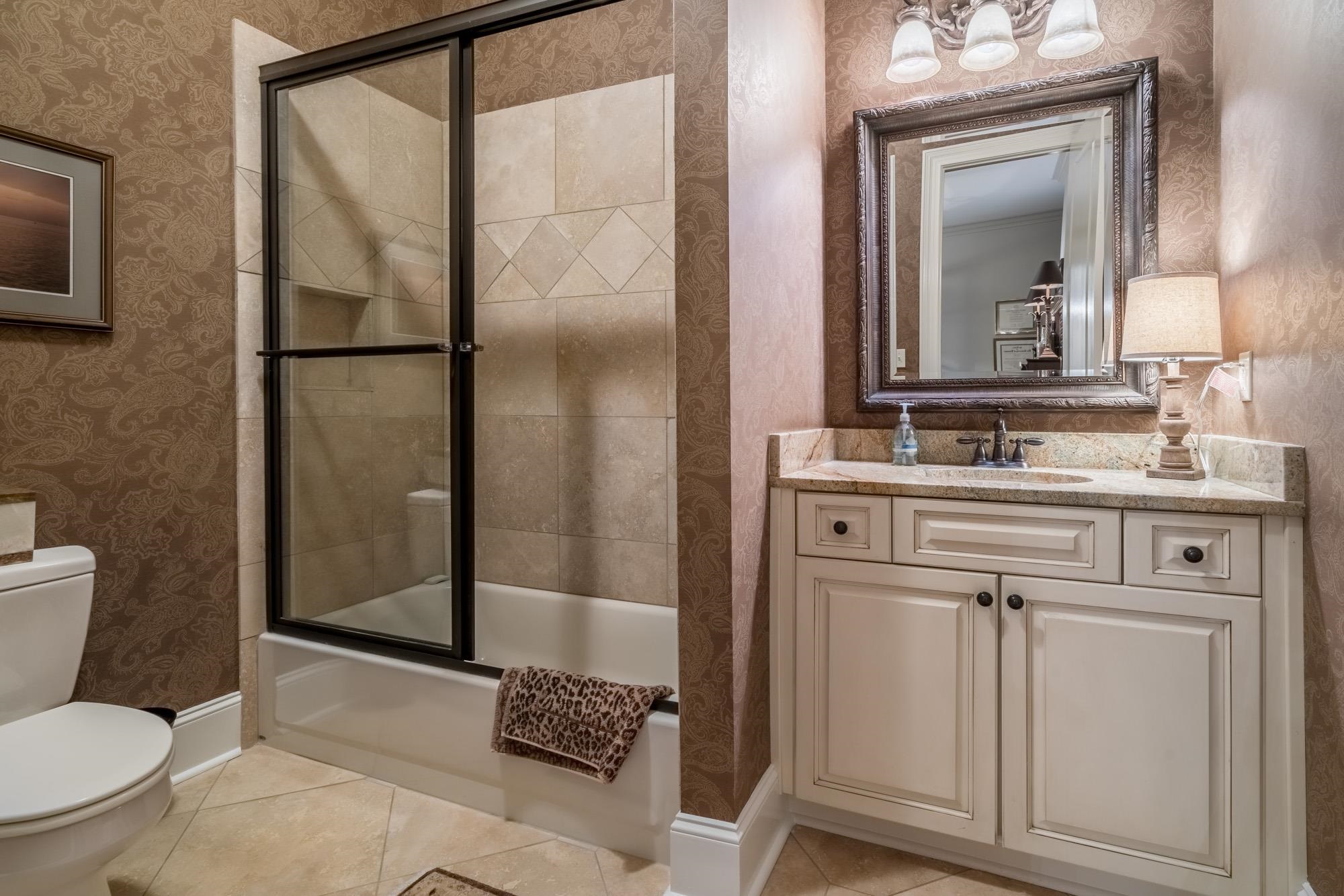 4410 Barfield Road Memphis, TN 38117 - Photo 8 of 25 a bathroom with a sink a toilet and a mirror