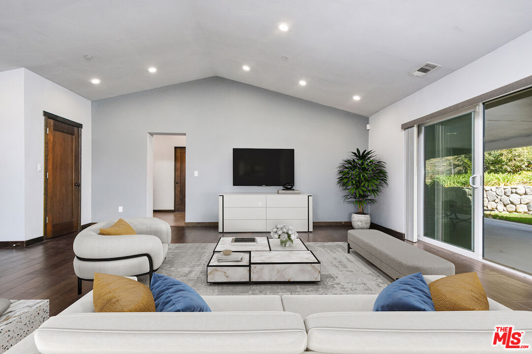 2447 Stonyvale Road Tujunga, CA 91042 - Photo 32 of 33 a living room with furniture and a flat screen tv
