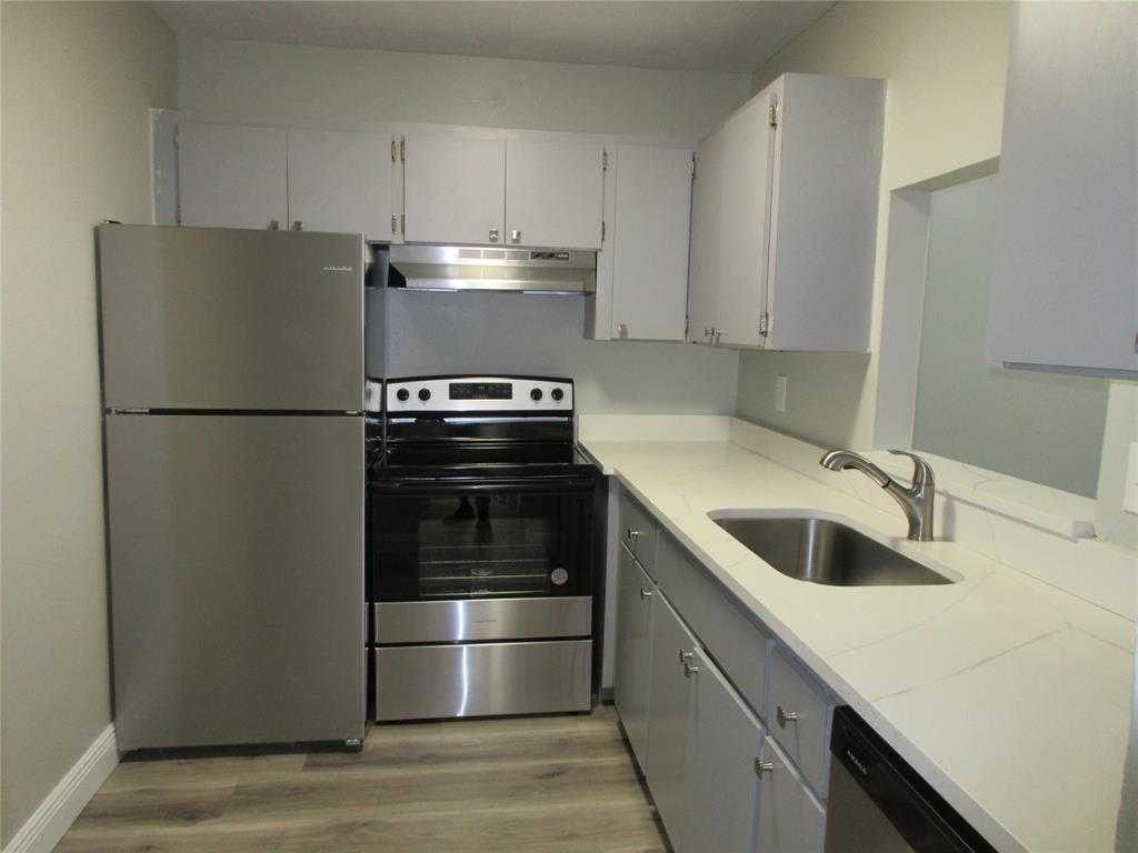 4240 Woodside Drive, Unit 4 Coral Springs, FL 33065 - Photo 6 of 13 a kitchen with a refrigerator sink and stove