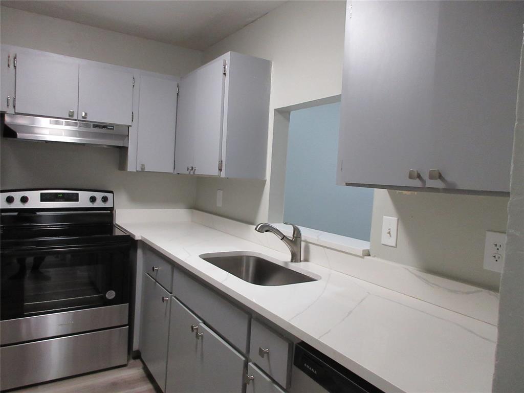 4240 Woodside Drive, Unit 4 Coral Springs, FL 33065 - Photo 8 of 13 a kitchen with a sink and a stove top oven