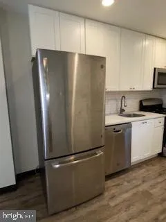 a white refrigerator freezer sitting in a kitchen
