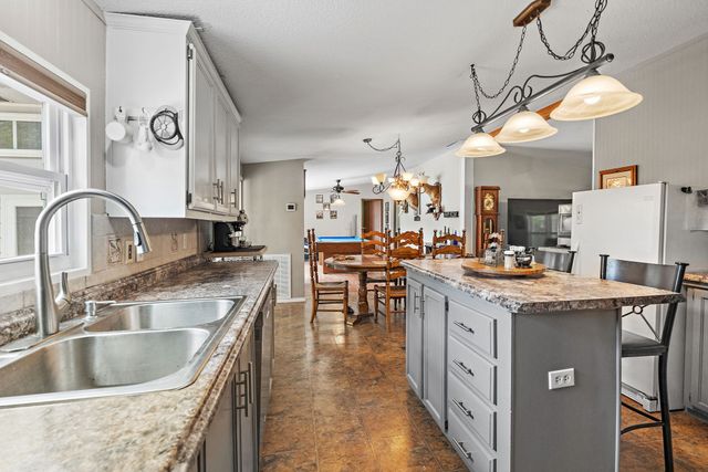a bedroom with a bed and a large mirror on the dresser