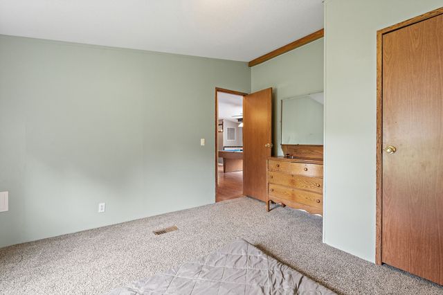 a view of a yard with wooden fence